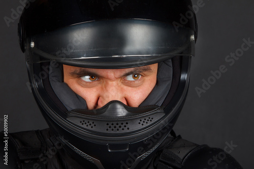 Biker in a helmet with a aggressive facial expression