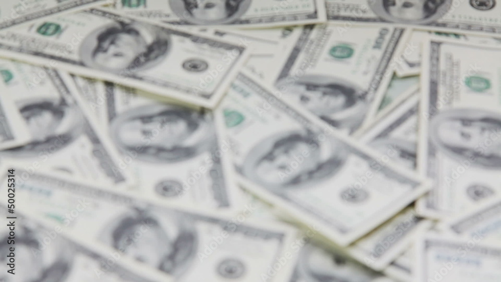 Changing focus on pile with american dollars Changing focus on pile with american dollars