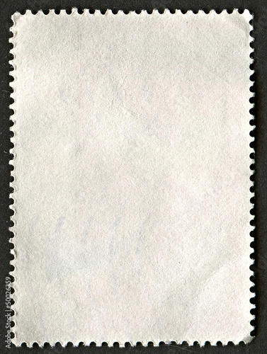 The reverse side of a postage stamp.