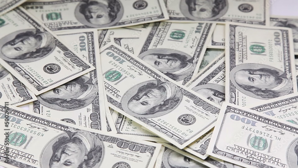 Sliding camera view on pile with american dollars Sliding camera view on pile with american dollars