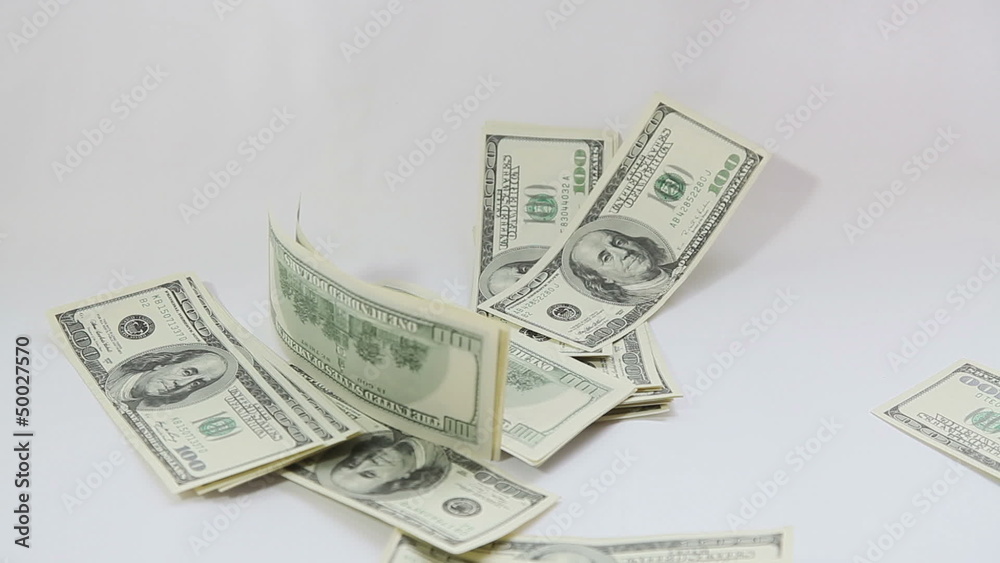American dollars falling on white background American dollars falling on white background