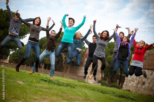 Group of Happy College Students Jumping at Park