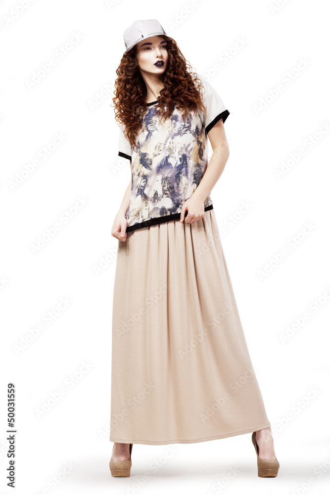 Modish Woman in Fashion dress and Cap posing. Studio shot