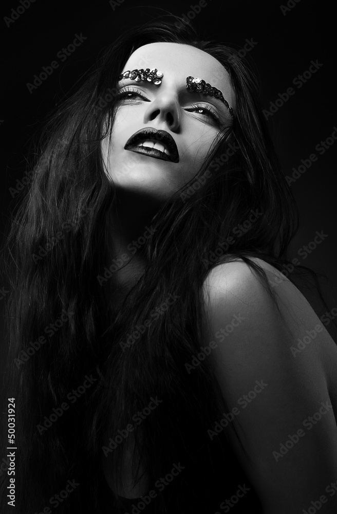 Luxurious Woman Face with Strass over Black background