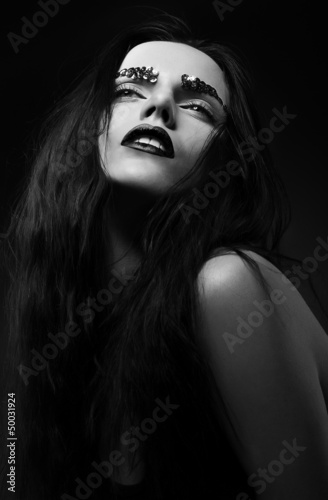 Luxurious Woman Face with Strass over Black background