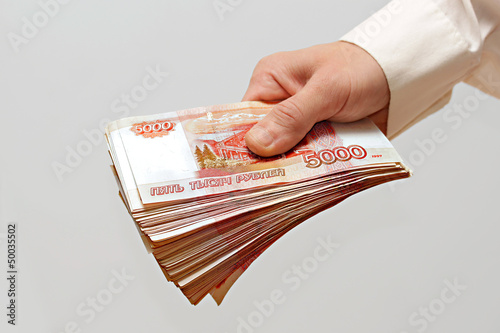 a bundle of money in the hand of a man