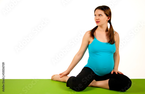 Pregnant young women stretching and exercising.