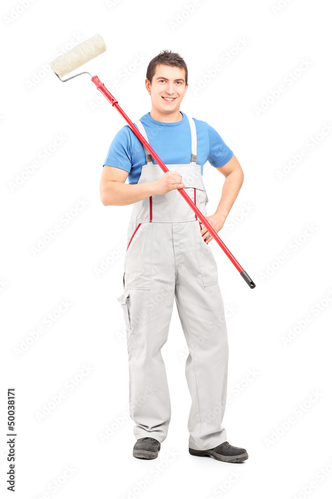 Full length portrait of a smiling painter in a uniform with a br Full length portrait of a smiling painter in a uniform with a br