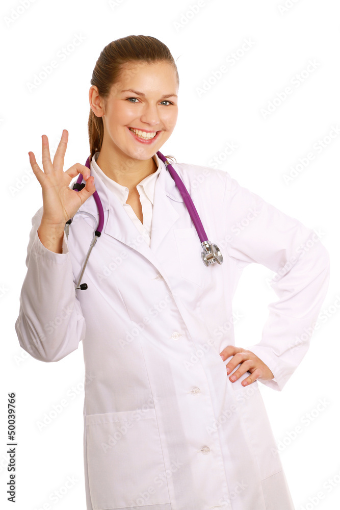 A female doctor shows a sign okay isolated on white background A female doctor shows a sign okay isolated on white background