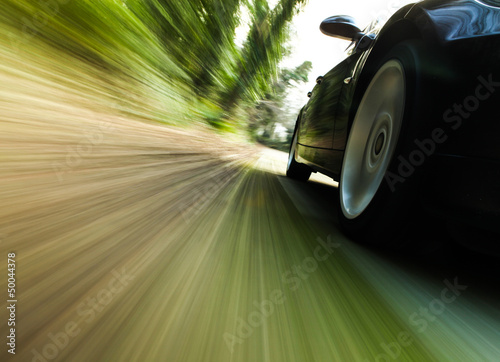 Side view of black car with heavy blurred motion. #50044378