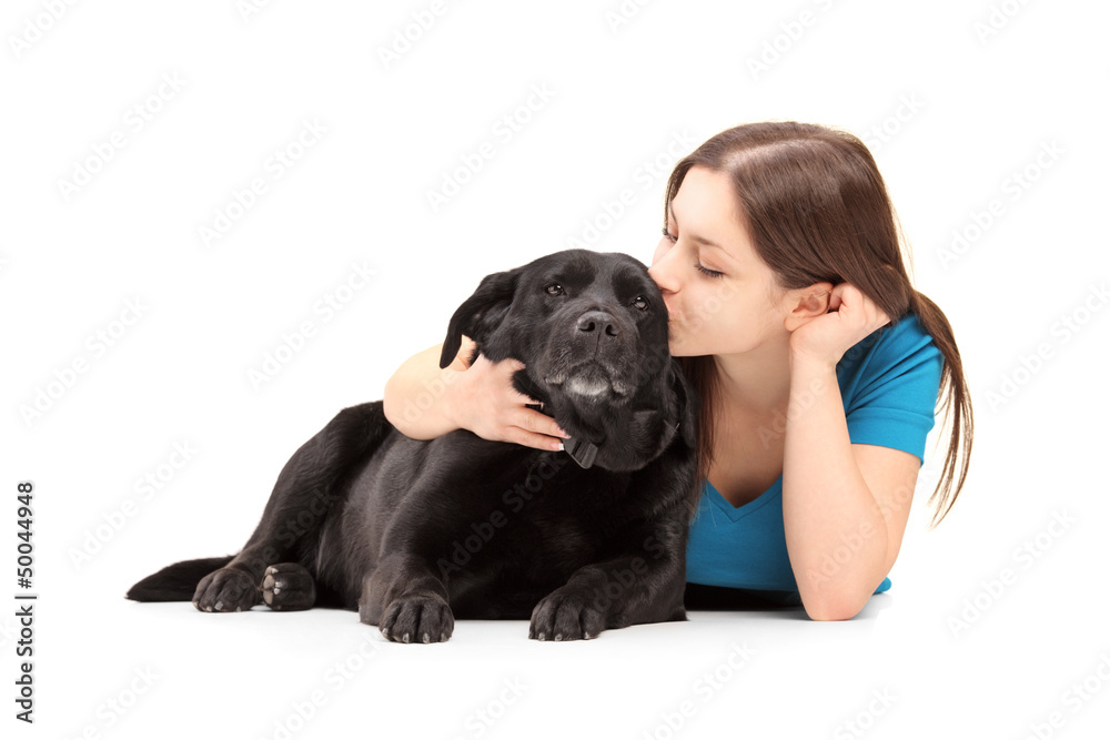 Young female hugging and kissing her dog Young female hugging and kissing her dog