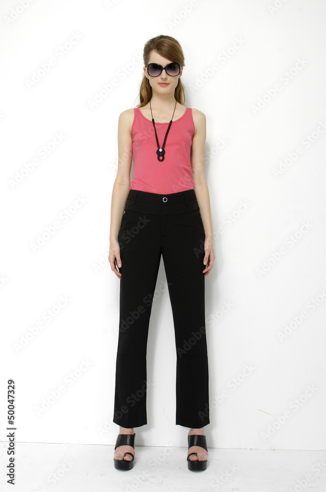 Fototapeta premium Young beautiful in sunglasses smiling stylish woman isolated