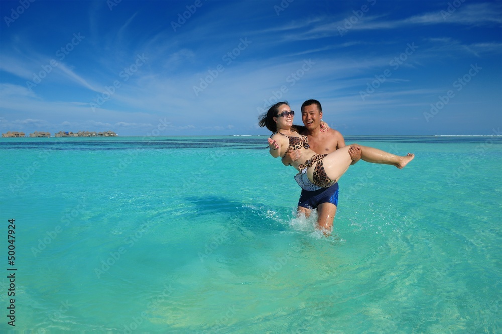 happy young couple enjoying summer on beach happy young couple enjoying summer on beach