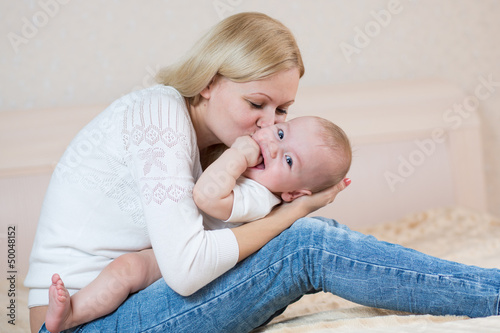 mother playing with baby bo...