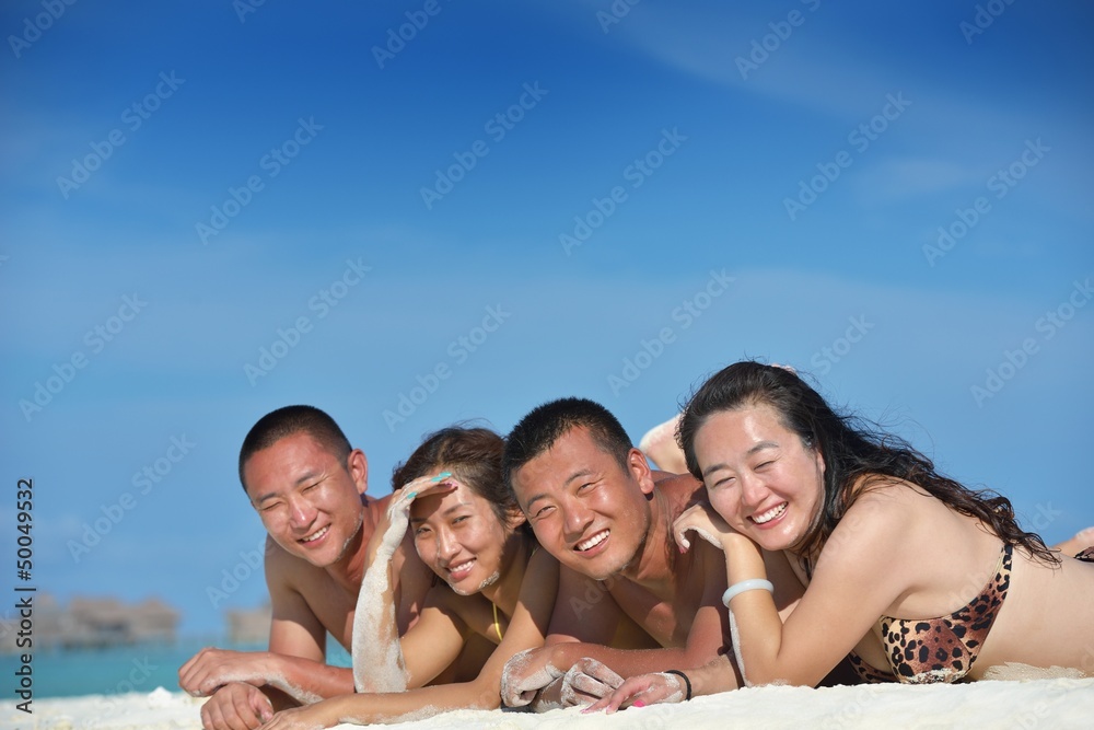 group of happy young people have fun on bach group of happy young people have fun on bach
