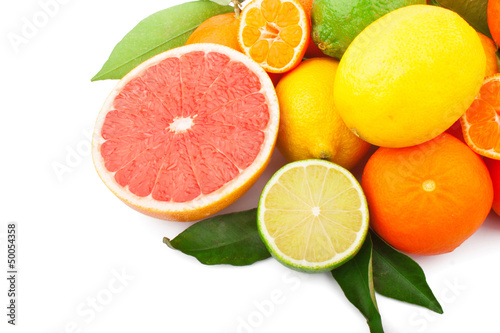 Fresh citrus fruits whole and half with green leaves, food