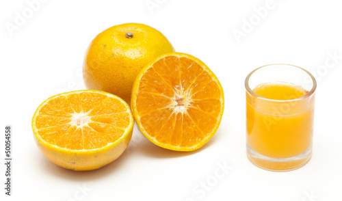 Orange juice and oranges isolated on white background