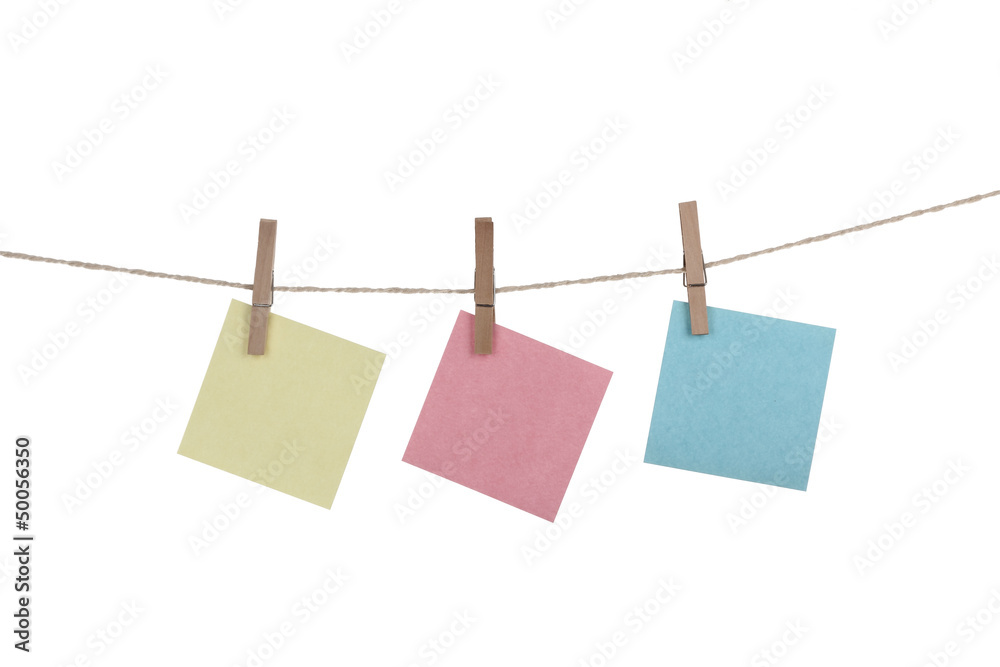 Blank paper cards hanging on clothespins Blank paper cards hanging on clothespins