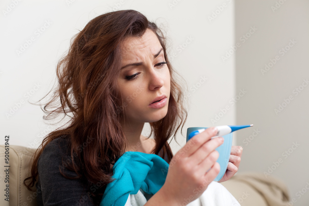 Sick woman measuring body temperature Sick woman measuring body temperature
