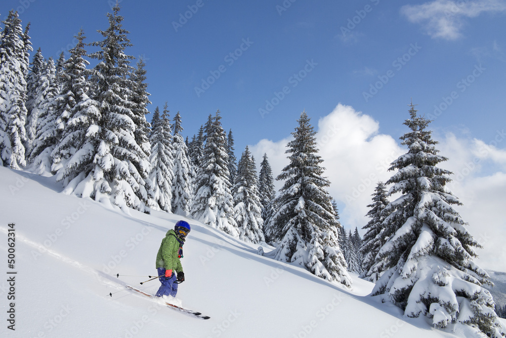 child skiing in powder snow in beautiful weather