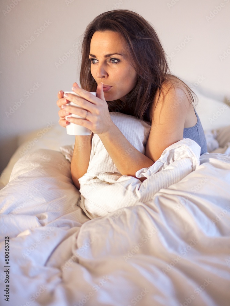 Woman Sipping Coffee While on Bed