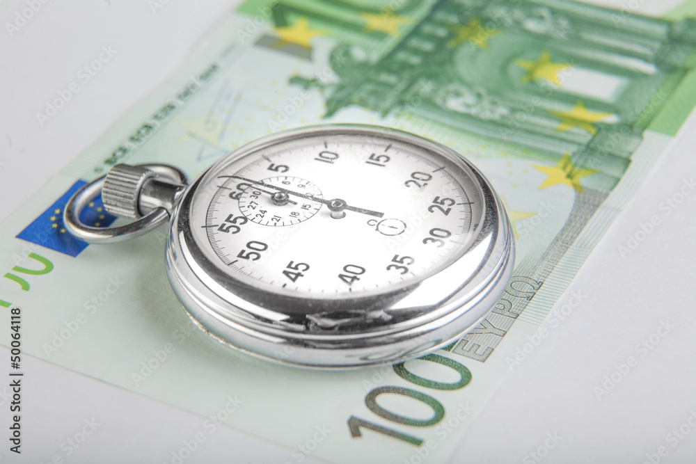 Stopwatch and a hundred euro banknote. Closeup Stopwatch and a hundred euro banknote. Closeup