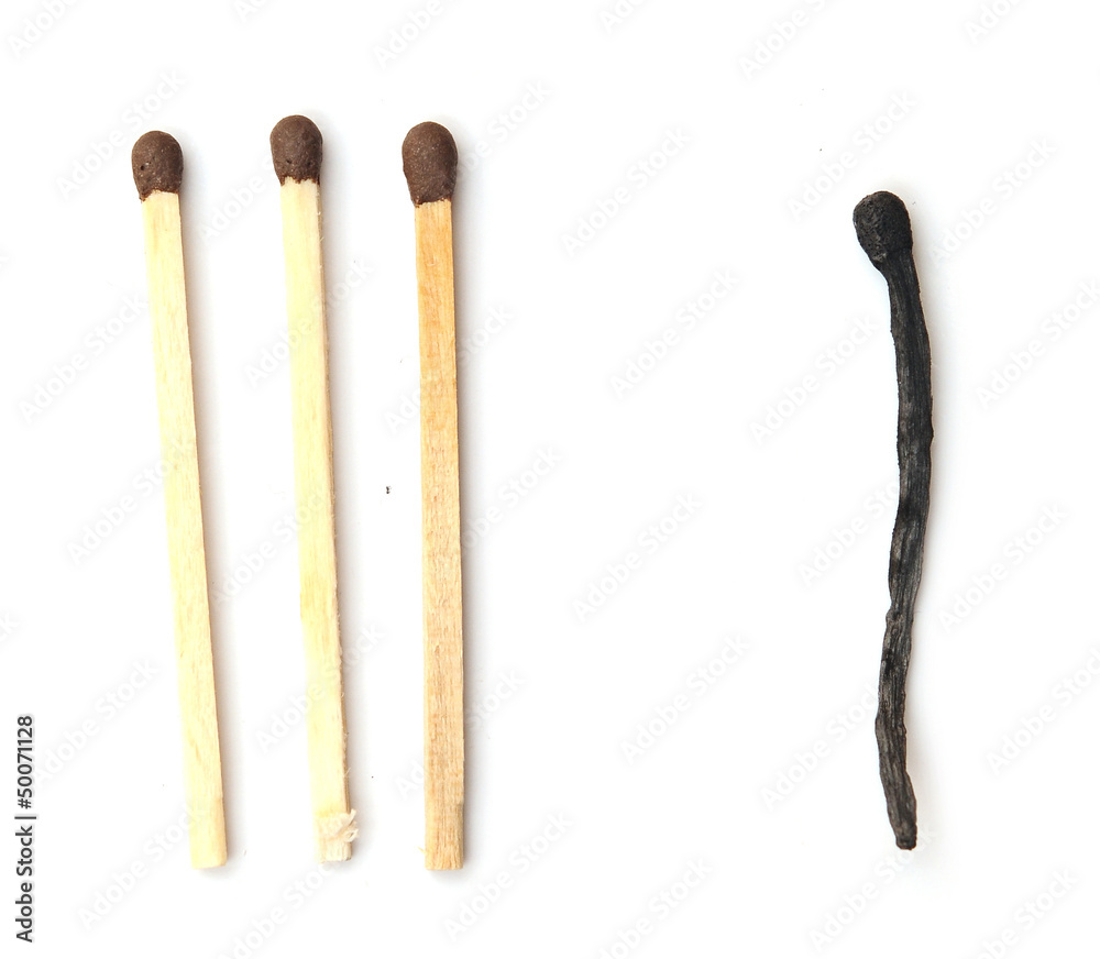 Close-up of a burnt match and a whole brown match isolated on a Close-up of a burnt match and a whole brown match isolated on a