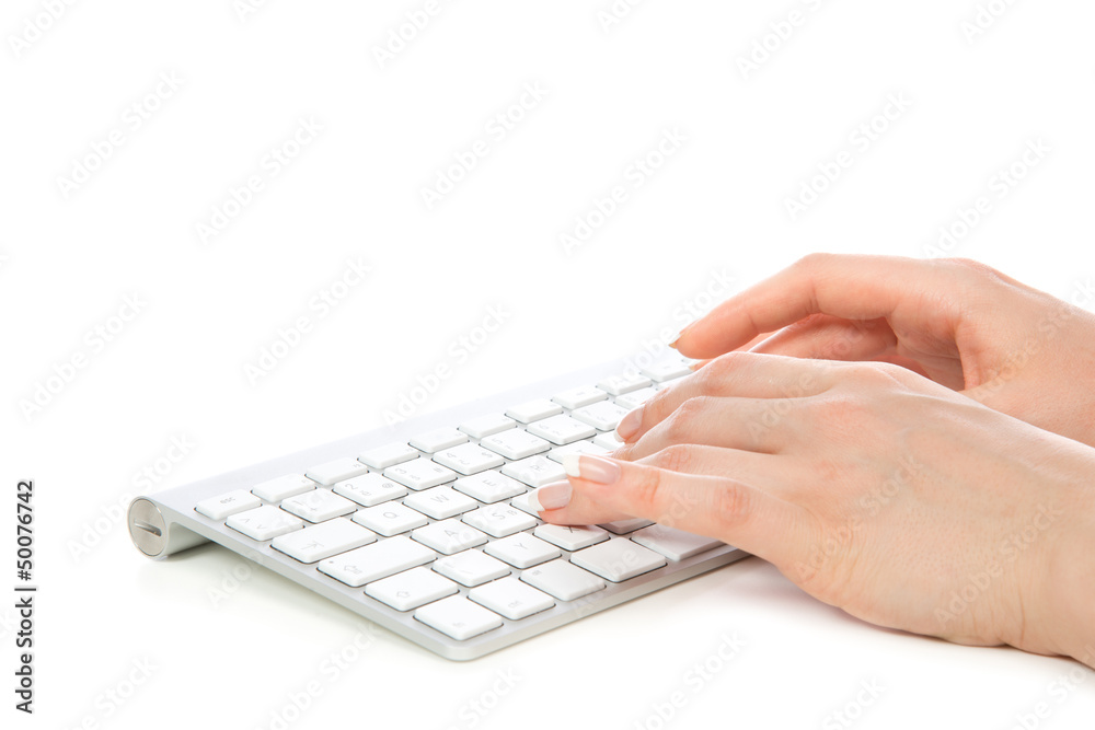 Hands typing on the remote wireless computer keyboard in Hands typing on the remote wireless computer keyboard in