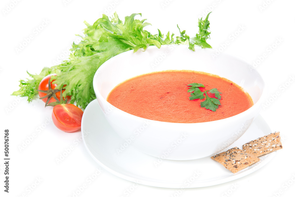 Tomato cream soup garnished with salad leaves Tomato cream soup garnished with salad leaves