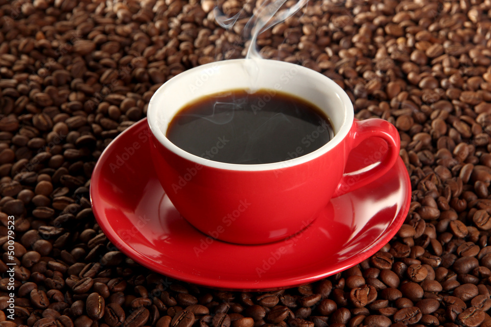 Cup of coffee on coffee beans background Cup of coffee on coffee beans background
