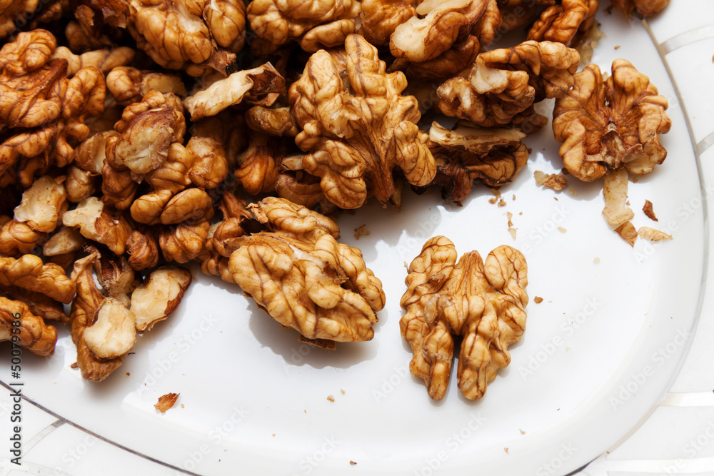 Raw wallnuts in a plate, horizontal shot Raw wallnuts in a plate, horizontal shot