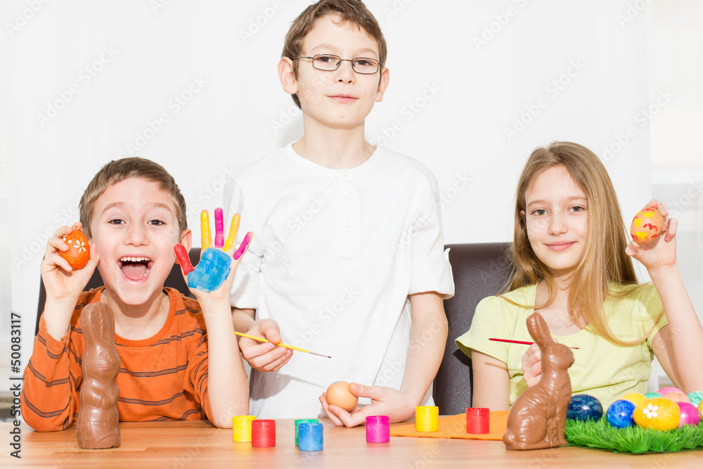 Children painting Easter eggs Children painting Easter eggs