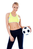 Female soccer player posing with ball