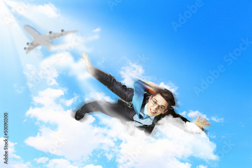 Young businessman flying with parachute on back