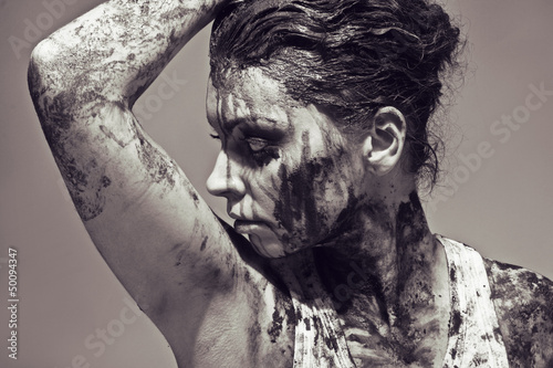 face and hands covered in mud photo