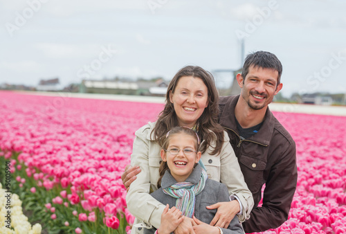 Family walks tulips field