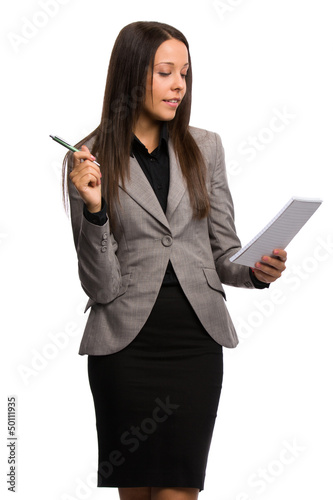 Business woman taking notes while observing the work process