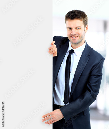 Handsome Businessman holding a blank sign in front of him