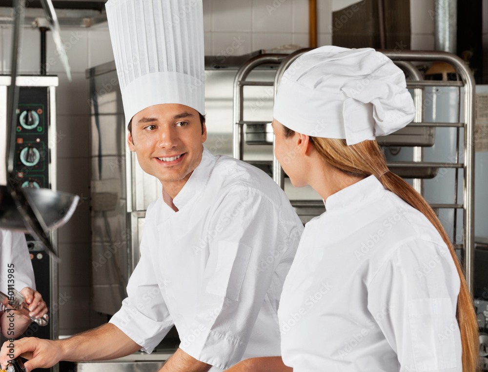 Male Chef With Colleague At Kitchen