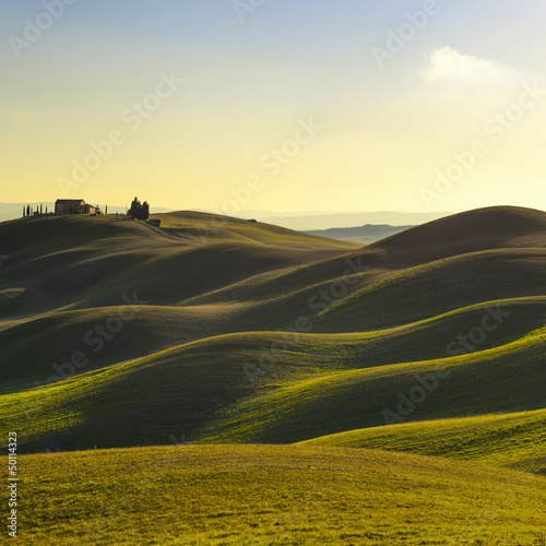 Tuscany, sunset rural landscape. Rolling hills and farm.