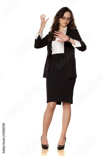 worried business woman looking at the clock on white background