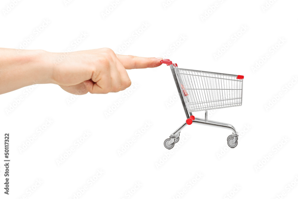 Finger pushing an empty shopping cart Finger pushing an empty shopping cart