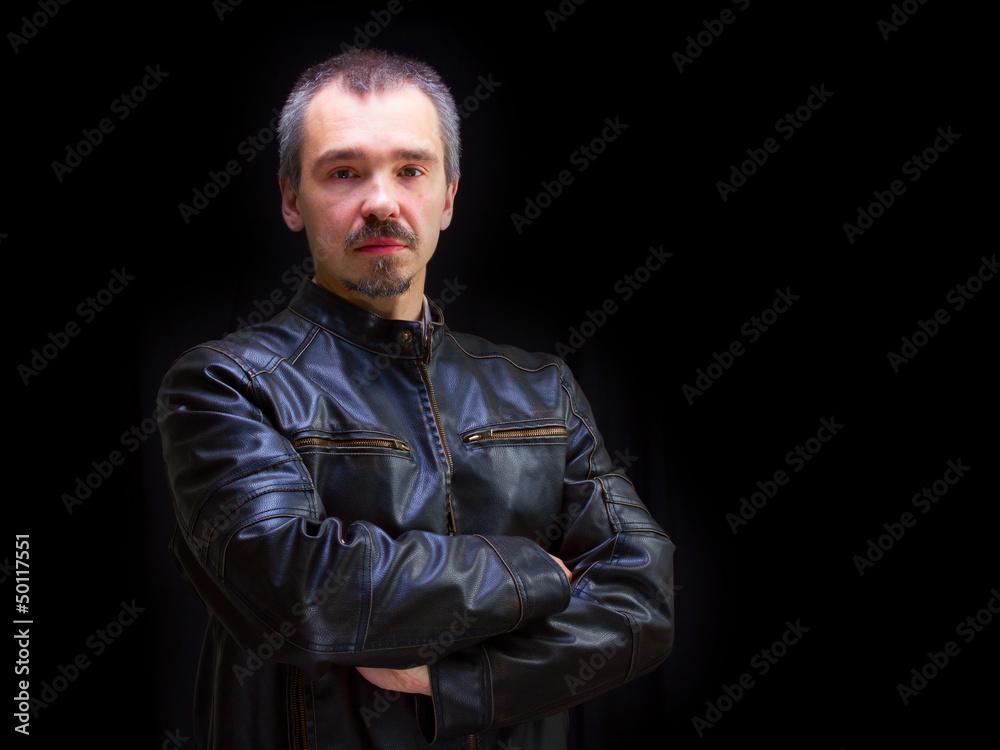 Obraz premium Adult motorcyclist in brown leather jacket.