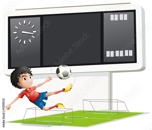 A soccer player inside the gym with a scoreboard