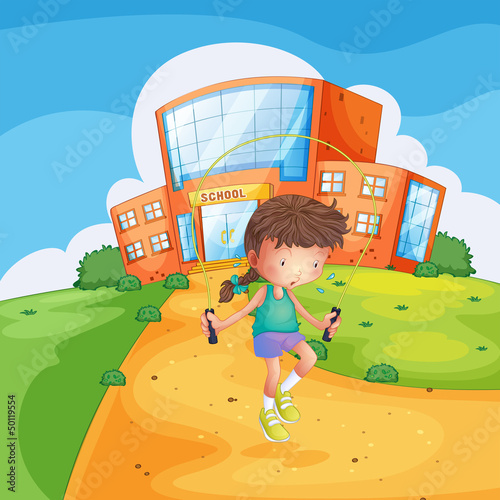 A sweaty girl playing in front of a school building