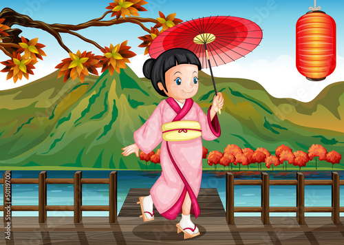 A lady wearing a pink kimono with an umbrella