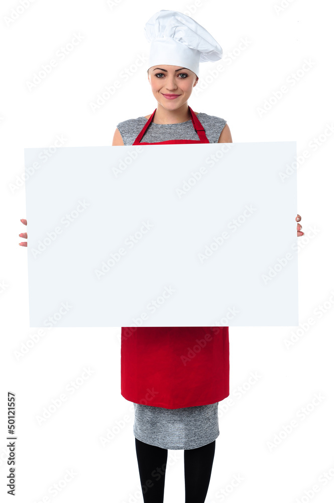 Young baker woman holding a blank whiteboard Young baker woman holding a blank whiteboard