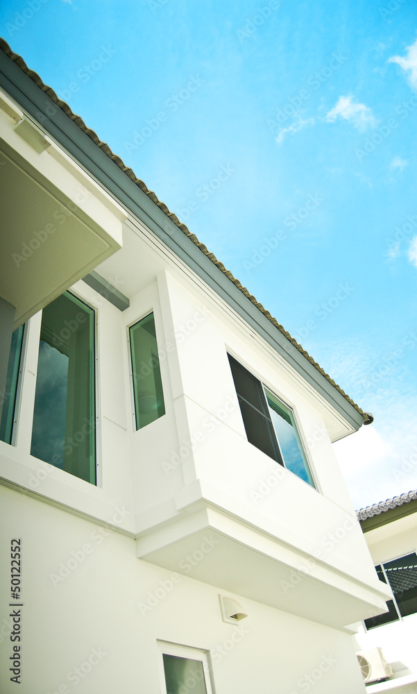 Modern white building with balcony on a blue sky Modern white building with balcony on a blue sky