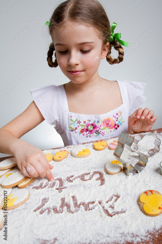 Happy Easter - lovely girl making easter cookies Happy Easter - lovely girl making easter cookies