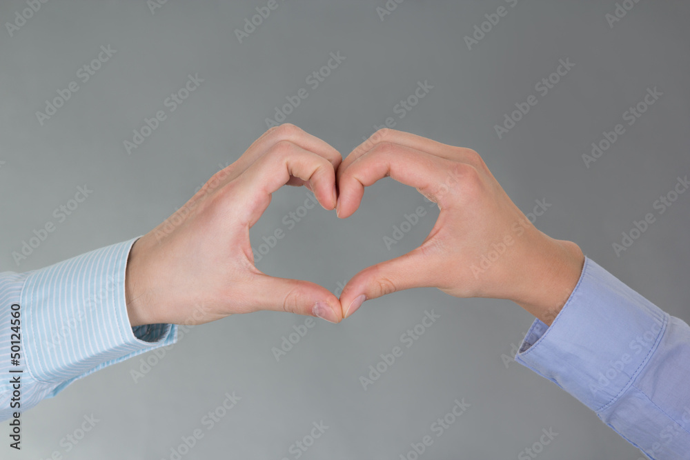 Obraz premium hands of man and woman forming a heart